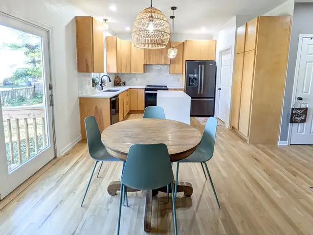 Contemporary kitchen in Lee's Summit, MO with maple cabinets, rattan pendant and round dining table